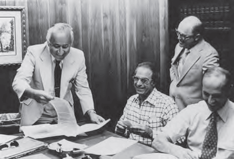 Signing Kinneret II mortgage, 1979. L-R: Jerry Bornstein, Murray Schwartz, Ernest Rapp (standing) and Elliott Zerivitz